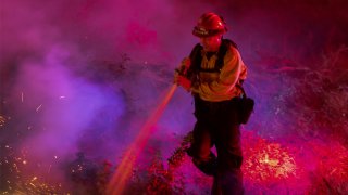 Firefighters control a backfire they set at the Maria Fire on Nov. 1, 2019 near Somis, California. (Photo by David McNew/Getty Images)