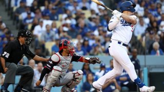 Joc Pederson #31 of the Los Angeles Dodgers hits a ground rule double in the first inning of game five of the National League Division Series against the Washington Nationals at Dodger Stadium on October 09, 2019 in Los Angeles, California.