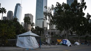 Tents sheltering homeless people line a residential street in Los Angeles, California, December 9, 2019. – At the behest of Los Angeles and local governments across the west, the US Supreme Court is considering a ruling by the 9th Circuit Court of Appeals that requires cities to allow people to sleep in public places including sidewalks as long as there are not enough public shelter beds for every person in need. Over half a million people in the US are homeless on a single night, according to a report released in September by the White House’s The Council of Economic Advisers. (Photo by Robyn Beck / AFP) (Photo by ROBYN BECK/AFP via Getty Images)