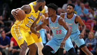 The Los Angeles Lakers’ LeBron James (23) works agains the Miami Heat’s Jimmy Butler (22) in the first quarter at the AmericanAirlines Arena in Miami on Friday, Dec. 13, 2019. (David Santiago/Miami Herald/Tribune News Service via Getty Images)