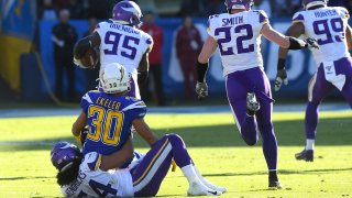 Middle linebacker Eric Kendricks #54 of the Minnesota Vikings forces a fumble by running back Austin Ekeler #30 of the Los Angeles Chargers allowing defensive end Ifeadi Odenigbo #95 of the Minnesota Vikings to grab the ball and run for a touchdown in the second quarter of the game at Dignity Health Sports Park on December 15, 2019 in Carson, California. (Photo by Jayne Kamin-Oncea/Getty Images)