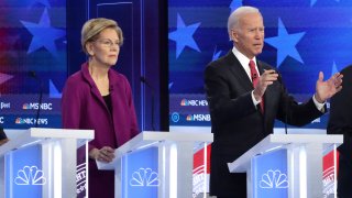In this Nov. 20, 2019, file photo, Democratic presidential candidates Sen. Elizabeth Warren (D-MA) and former Vice President Joe Biden participate in the Democratic Presidential Debate at Tyler Perry Studios November 20, 2019 in Atlanta, Georgia.
