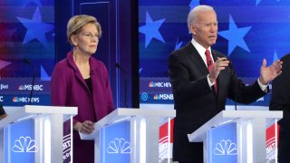 In this Nov. 20, 2019, file photo, Democratic presidential candidates Sen. Elizabeth Warren (D-MA) and former Vice President Joe Biden participate in the Democratic Presidential Debate at Tyler Perry Studios November 20, 2019 in Atlanta, Georgia.