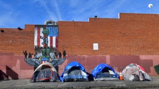 Tents for the homeless line a sidewalk in Los Angeles, California on December 17, 2019.