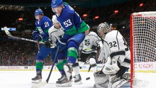 Bo Horvat #53 of the Vancouver Canucks looks on as Jonathan Quick #32 of the Los Angeles Kings makes a save during their NHL game at Rogers Arena December 28, 2019 in Vancouver, British Columbia, Canada. Vancouver won 3-2.