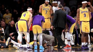 Alex Caruso #4, JaVale McGee #7, Rajon Rondo #9 and Dwight Howard #39 look on as Anthony Davis #3 of the Los Angeles Lakers lies on the ground after being injured contesting a shot by Julius Randle #30 of the New York Knicks look on during the second half of a game at Staples Center on January 07, 2020 in Los Angeles, California. NOTE TO USER: User expressly acknowledges and agrees that, by downloading and/or using this photograph, user is consenting to the terms and conditions of the Getty Images License Agreement (Photo by Sean M. Haffey/Getty Images)