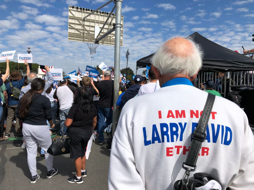 Jeff Jones, 77, wearing his "I am not Bernie Sanders" sweater, attends a Bernie Sanders rally at a Santa Ana, California, high school on February 21, 2020. - Up until a few years ago, Jeff Jones was going about his life, minding his own business and enjoying his passion for music. Then Bernie Sanders burst onto the national political stage, prompting many to do double takes on seeing Jones, who bears a striking resemblance to the Democratic presidential candidate.