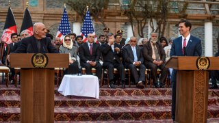 Afghanistan's President Ashraf Ghani, left, speaks as U.S. Secretary of Defense Mark Esper, right, listens