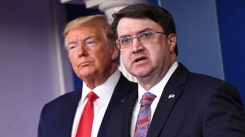 In this March 18, 2020, file photo, Robert Wilkie, U.S. Department of Veterans Affairs secretary, speaks while President Donald Trump, left, listens during a Coronavirus Task Force news conference in the briefing room of the White House in Washington, D.C.
