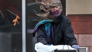 A shopper struggles with the wind.