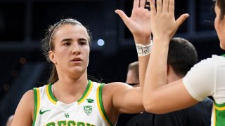 Sabrina Ionescu of the Oregon Ducks high-fives teammates on the bench after coming out of the game late in the team's 89-56 victory over the Stanford Cardinal during the championship game of the Pac-12 Conference women's basketball tournament at the Mandalay Bay Events Center on March 8, 2020 in Las Vegas, Nevada. The Ducks defeated the Cardinal 89-56.
