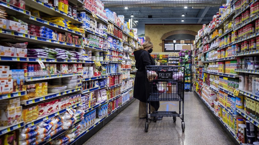 A shopper wearing a protective mask walks down an aisle at a grocery store in Chicago, on May 7, 2020.