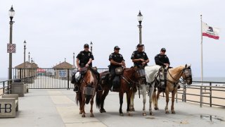 File Image: Mounted police monitor protesters on the Huntington Beach Pier during the demonstration.
Citizens staged a protest in front of the Huntington Beach Pier to demand for the reopening of the California economy.