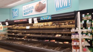 Empty shelves are visible in the meat section, with a sign reading Kosher Meat, at the Best Market supermarket on Long Island, New York during an outbreak of the COVID-19 coronavirus, March 14, 2020.