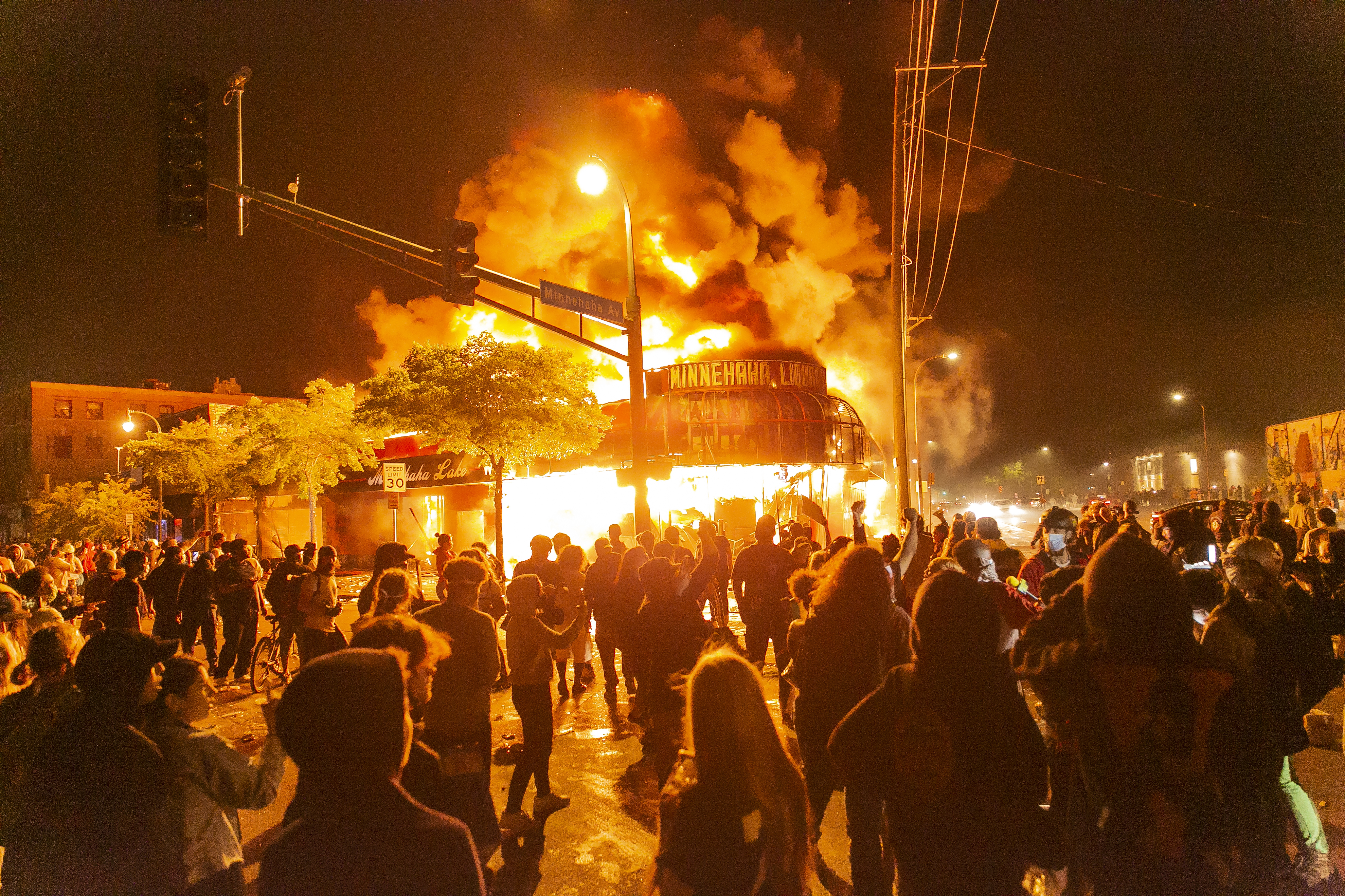 Protesters set a shop on fire on Thursday, May 28, 2020, during the third day of protests over the death of George Floyd in Minneapolis.