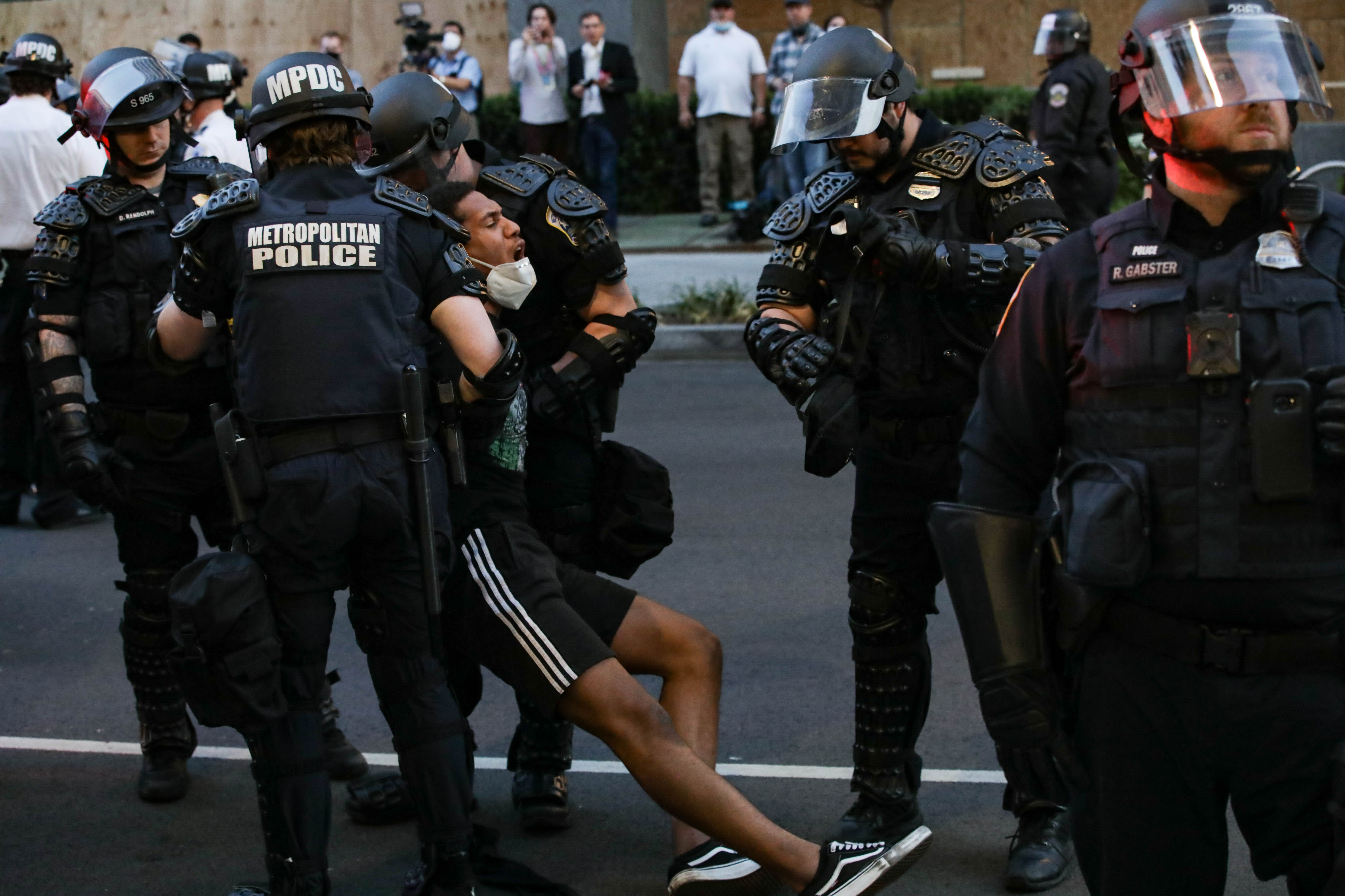 Police detain and arrest a man during a protest over the death of George Floyd, an unarmed black man who died after being pinned down by a white police officer in Washington, D.C., June 1, 2020. Protests and riots continue in cities across US following the death of George Floyd for the seventh night in a row.