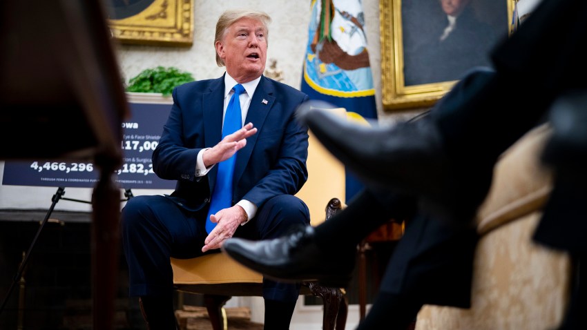 President Donald Trump talks to reporters while meeting with Iowa Governor Kim Reynolds in the Oval Office at the White House as he continues to promote re-opening business during the coronavirus pandemic May 6, 2020, in Washington, DC. Reynolds lifted some restrictions May 1 in 77 of her state's counties, allowing gyms, restaurants and retail stores to reopen while areas and counties that have been hard hit by the outbreak remain closed.