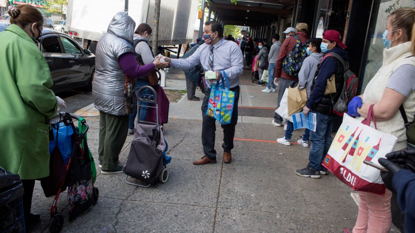 A long line forms to receive free food from a food pantry run by the Council of Peoples Organization on May 15, 2020 in the Midwood neighborhood of Brooklyn, New York.
