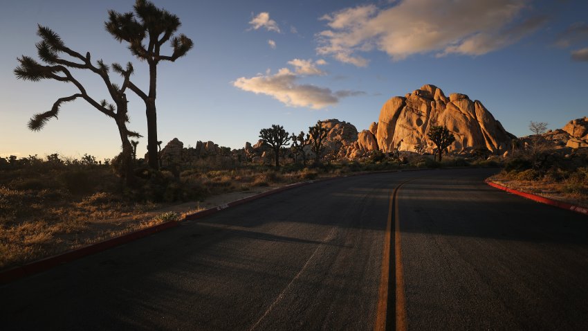 A road leads toward rock formations in Joshua Tree National Park one day after the park reopened after being closed for two months due to the coronavirus pandemic on May 18, 2020 in Joshua Tree National Park, California.