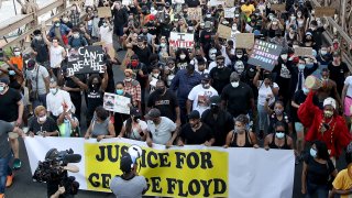 Terrence Floyd (Yankees Cap), brother of George Floyd walks with activists across the Brooklyn Bridge during a rally in response to the killing of his brother by Minneapolis police on June 04, 2020 in the Brooklyn borough of New York City.
