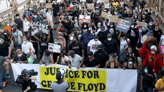 Terrence Floyd (Yankees Cap), brother of George Floyd walks with activists across the Brooklyn Bridge during a rally in response to the killing of his brother by Minneapolis police on June 04, 2020 in the Brooklyn borough of New York City.