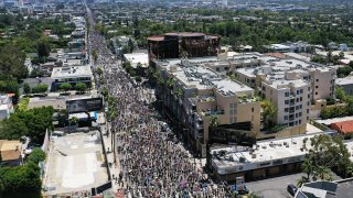 An aerial view as protesters walk on Sunset Boulevard during the All Black Lives Matter solidarity march, replacing the annual gay pride celebration, as protests continue in the wake of George Floyd’s death on June 14, 2020 in Los Angeles, California.