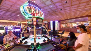 People play a video craps machine at a hotel-casino