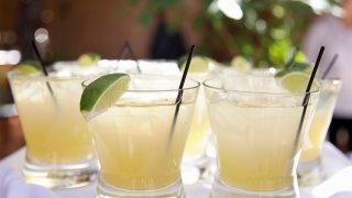 The margarita is a cocktail consisting of tequila mixed with orange-flavored liqueur and lime or lemon juice, often served with salt on the glass rim.