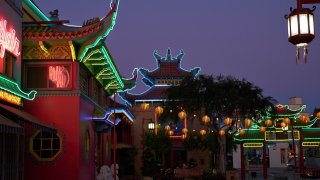 An early evening view of neon outlined buildings in Los Angeles’s Chinatown