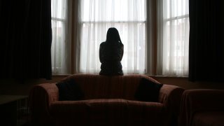 Domestic violence survivor looking out a window