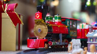 Shallow DOF Christmas scene with toy train, gifts and clorful lights.
