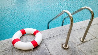Life ring at swimming pool.emergency tire floating at swimming pool.