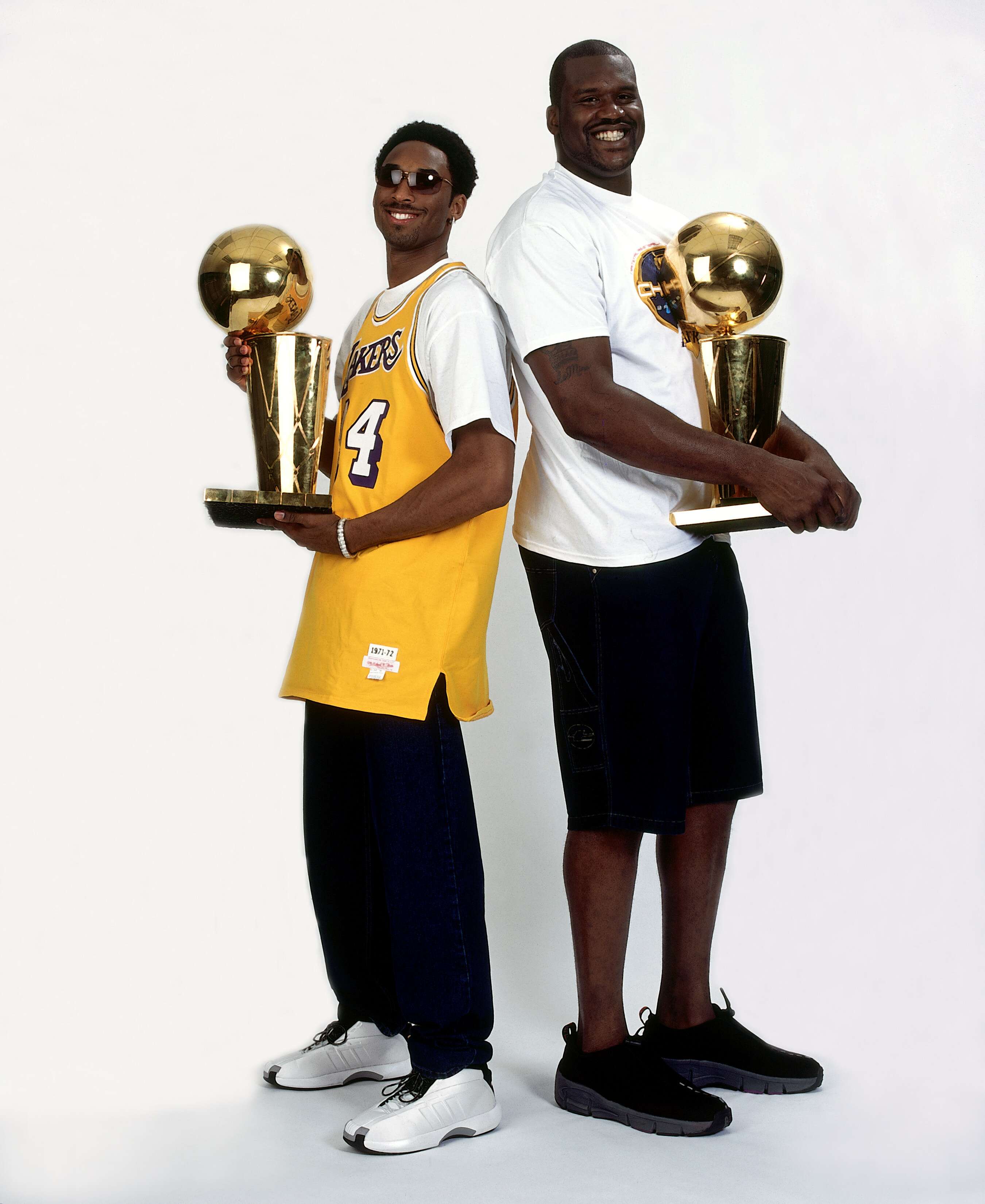 Kobe Bryant of the Los Angeles Lakers holds the championship