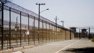 The California Institution for Men prison fence is seen on August 19, 2009 in Chino, California. Up until an inmate from the California Institution for Women in Corona died on Tuesday from what appear to be complications related to the coronavirus, it was the sole site of virus-related deaths in California prisons.