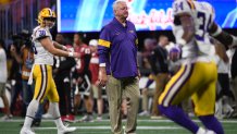 LSU Offensive Coordinator Steve Ensminger watches teams warm up before the first half of the Peach Bowl NCAA semifinal college football playoff game between LSU and Oklahoma, Saturday, Dec. 28, 2019, in Atlanta. Ensminger’s daughter-in-law, Carley McCord, died in a plane crash Saturday in Louisiana on the way to the game. (AP Photo/Danny Karnik)