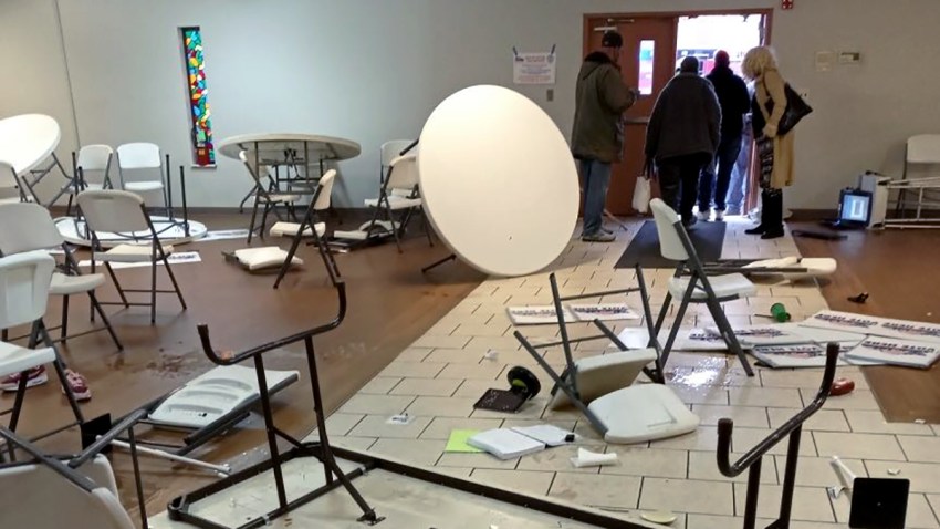 Workers at a St. Louis, Missouri, polling station survey the damage after a driver slammed his car into the church, knocking over chairs and tables and shouting obscenities, police said. No injuries were reported.