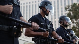 LOS ANGELES, CA – MAY 27:
Los Angeles Police Department officers form a police line in riot gear after a Black Lives Matter Protest in solidarity with other national demonstrations to show outrage over the death of George Floyd in downtown Los Angeles on Wednesday, May 27, 2020 in Los Angeles, CA.
(Gabriella Angotti-Jones / Los Angeles Times via Getty Images)