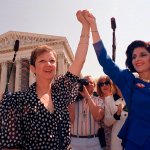 In this April 26, 1989, file photo, Norma McCorvey, Jane Roe in the 1973 court case, left, and her attorney Gloria Allred hold hands as they leave the Supreme Court building in Washington after sitting in while the court listened to arguments in a Missouri abortion case.