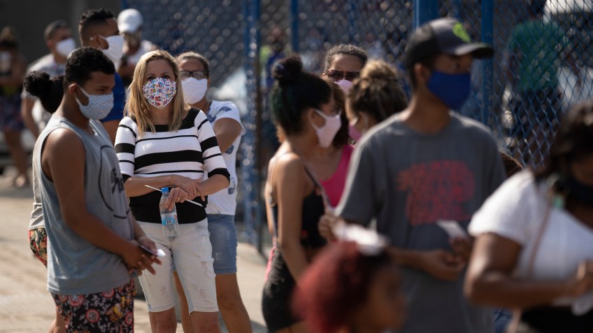 People wait in line for a COVID-19 test amid the new coronavirus pandemic at a plaza in Duque de Caxias, Brazil, Monday, June 8, 2020. Brazil's government has stopped publishing a running total of coronavirus deaths and infections in an extraordinary move that critics call an attempt to hide the true toll of the disease in Latin America's largest nation.
