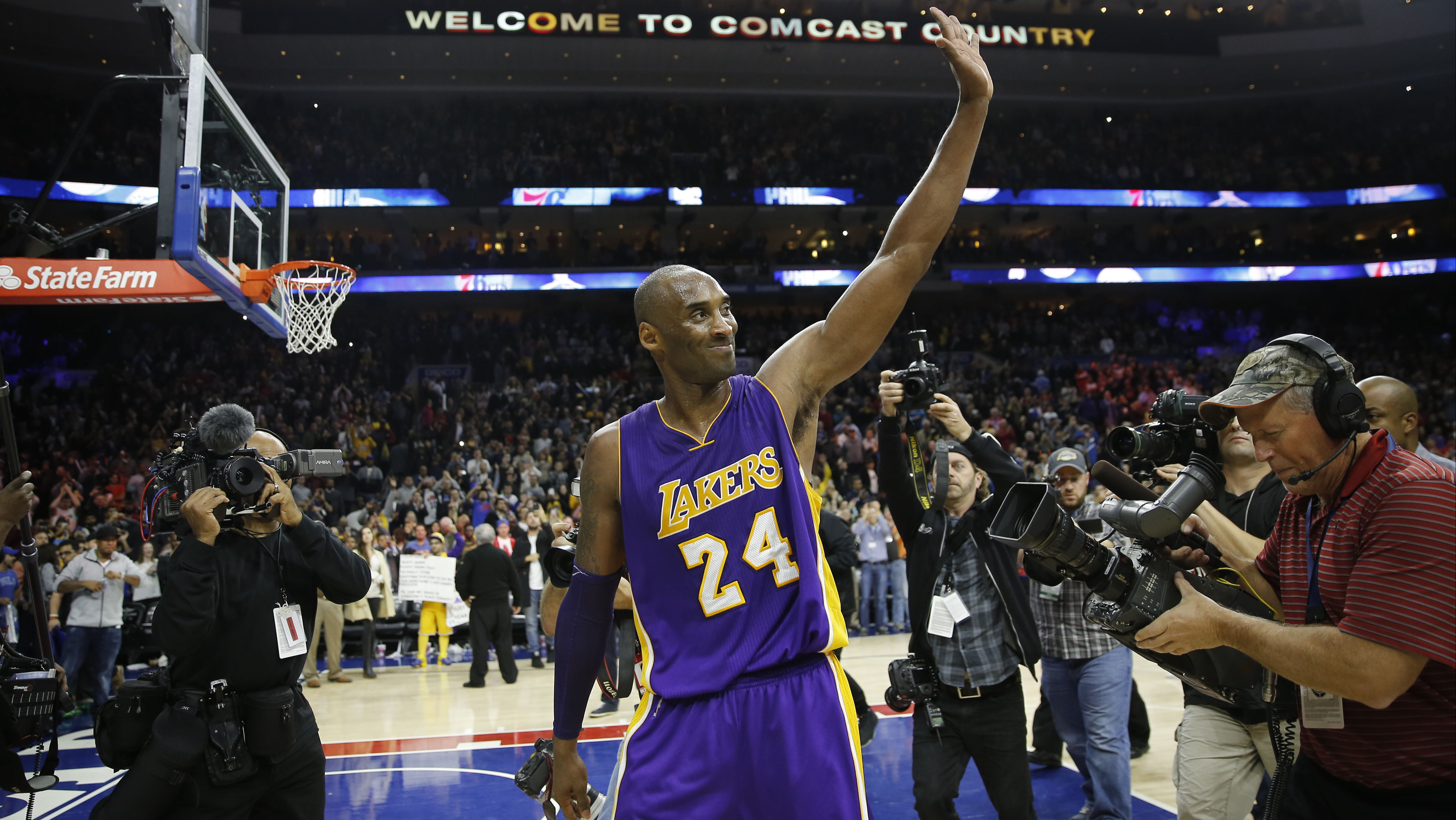 NBA - Kobe Bryant #24 of the Los Angeles Lakers adjusts his jersey