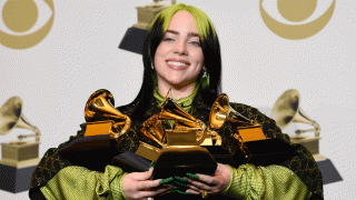 In this Jan. 26, 2020, file photo, Billie Eilish poses in the press room with the awards for best album and best pop vocal album for "We All Fall Asleep, Where Do We Go?", best song and record for "Bad Guy" and best new artist at the 62nd annual Grammy Awards at the Staples Center in Los Angeles.