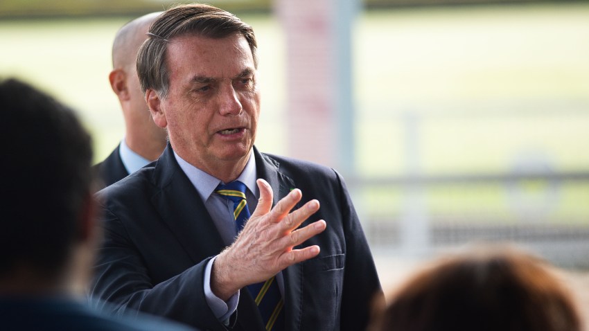 President of Brazil Jair Bolsonaro talks to supporters of his government who waited for him outside the Palácio do Alvorada amidst the coronavirus (COVID-19) pandemic on May 6, 2020 in Brasilia.