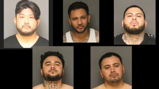Five men were arrested in a burglary ring that netted $1.9 million in cash, designer watches and bags, guns, and more across several counties, the OC District Attorney announced May 18, 2020.