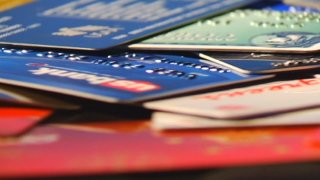 Stack of unidentifiable credit cards on a table