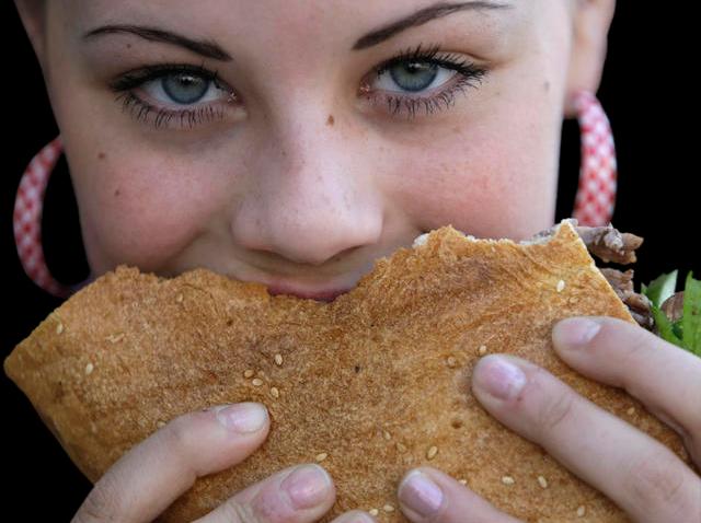 102408 girl eats sandwich