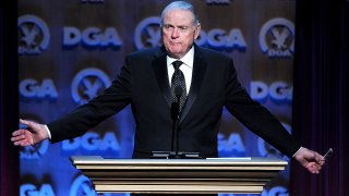 Broadcaster Keith Jackson is seen at a podium.