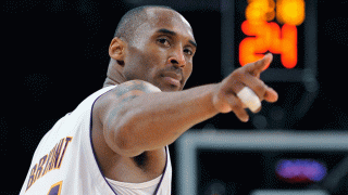 FILE - In this June 7, 2009 file photo Los Angeles Lakers guard Kobe Bryant (24) points to a player behind him after making a basket in the closing seconds against the Orlando Magic in Game 2 of the NBA basketball finals in Los Angeles.