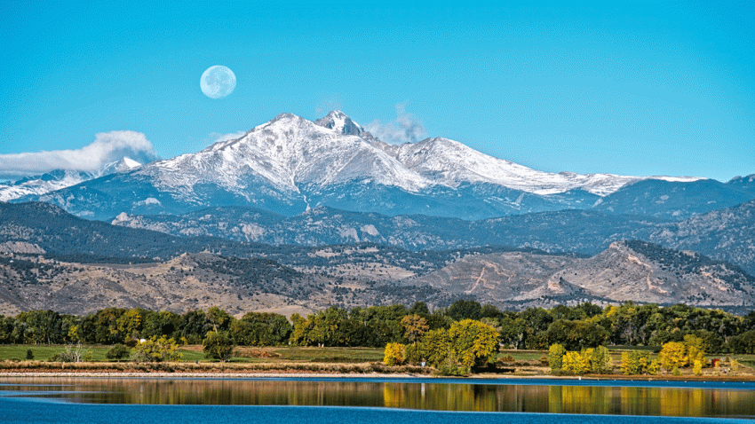 File photo - A full moon setting over Longs Peak in Longmont, Colorado, across McIntosh Lake.