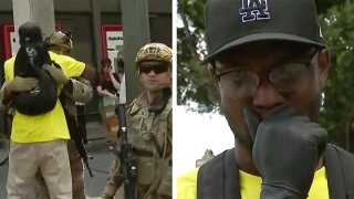 protester hugs national guardsman