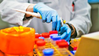 In this file photo, a researcher works in a lab that is developing testing for the COVID-19 coronavirus at Hackensack Meridian Health Center for Discovery and Innovation on February 28, 2020 in Nutley, New Jersey.